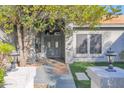 Inviting front entry with gray door and stone pathway at 5714 E Paradise Ln, Scottsdale, AZ 85254