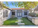 Private side entrance with stone walkway and artificial turf at 5714 E Paradise Ln, Scottsdale, AZ 85254