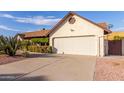 House exterior featuring a large garage and desert landscaping at 6026 W Juniper Ave, Glendale, AZ 85306