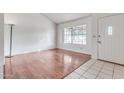 Bright living room with hardwood floors and large window at 6026 W Juniper Ave, Glendale, AZ 85306