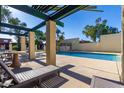 Relaxing pool area with shaded seating and tables at 6508 N 24Th Ln, Phoenix, AZ 85015