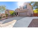 Two-story house with a large driveway and desert landscaping at 6857 W Juana Dr, Peoria, AZ 85383