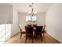 Dining room with hardwood floors and a dark wood table with six chairs at 6902 S 14Th Dr, Phoenix, AZ 85041