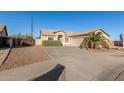 Front view of a single-story house with a two-car garage and desert landscaping at 6902 S 14Th Dr, Phoenix, AZ 85041