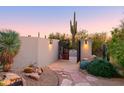 Modern entry gate with desert landscaping at 7002 E Leisure Ln, Carefree, AZ 85377