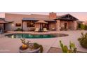 Relaxing kidney-shaped pool with patio seating at 7002 E Leisure Ln, Carefree, AZ 85377