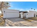 Contemporary home's exterior features a clean design and attached garage at 8165 E Del Cuarzo Dr, Scottsdale, AZ 85258