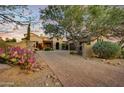 Elegant home exterior with a brick driveway and desert landscaping at 8787 E Lost Gold Cir, Gold Canyon, AZ 85118