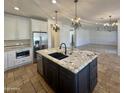 Eat-in kitchen with island, granite counters & stainless steel appliances at 910 E Canyon Way, Chandler, AZ 85249