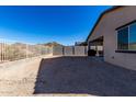 Large backyard with gravel, block wall, and mountain views at 17244 W Lynx Rd, Goodyear, AZ 85338