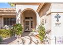 Front entry with arched doorway and decorative accents at 18064 W Buena Vista Dr, Surprise, AZ 85374
