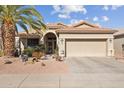 House exterior with palm tree and a paved driveway at 18064 W Buena Vista Dr, Surprise, AZ 85374