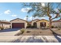 Front view of a one-story house with a two-car garage at 19241 N Emerald Cove Way, Surprise, AZ 85387