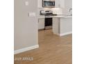 Modern kitchen featuring white cabinets, tile backsplash, and island at 21022 N 58Th Way, Phoenix, AZ 85054