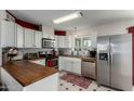 Updated kitchen with wood countertops and stainless steel appliances at 261 W 21St Ave, Apache Junction, AZ 85120