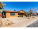 Front view of the house with driveway and landscaping at 3428 W Vogel Ave, Phoenix, AZ 85051