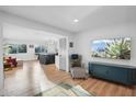 Open concept living space with view into modern kitchen at 3802 E Piccadilly Rd, Phoenix, AZ 85018