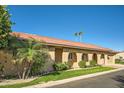 Side view of a tan house with arched entryways and red tile roof at 7927 E Sage Dr, Scottsdale, AZ 85250