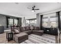 Spacious living room with L-shaped sectional sofa and large windows at 11054 E Utopia Ave, Mesa, AZ 85212