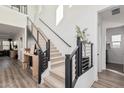 Modern staircase with metal railing and light wood flooring at 11054 E Utopia Ave, Mesa, AZ 85212