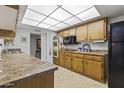 Bright kitchen featuring wood cabinets and modern appliances at 13416 N Cedar Dr, Sun City, AZ 85351