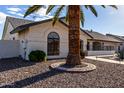 Single-story home showcasing a palm tree and landscaping at 13907 W Terra Vista Dr, Sun City West, AZ 85375