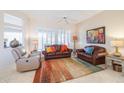 Comfortable living room with leather seating and a colorful area rug at 14309 W Rico Dr, Sun City West, AZ 85375