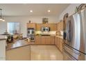 Spacious kitchen with light wood cabinets and stainless steel appliances at 14848 W Edgemont Ave, Goodyear, AZ 85395