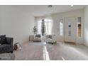 Bright living room with large windows and comfortable seating at 14848 W Edgemont Ave, Goodyear, AZ 85395