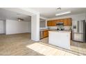 Kitchen with island, stainless steel appliances, and wood cabinets at 15819 W Crocus Dr, Surprise, AZ 85379