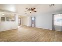 Bright living room with tile floors and ceiling fan at 15819 W Crocus Dr, Surprise, AZ 85379