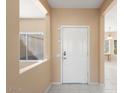 Light and bright entryway with neutral walls and tile flooring at 15920 W Summerwalk Dr, Surprise, AZ 85374