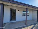 Modern front entrance with a covered porch and stylish door at 1633 N 62Nd Ave, Phoenix, AZ 85035