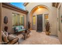 Charming courtyard entry with seating area and tile flooring at 1646 W Ainsworth Dr, Anthem, AZ 85086