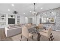 Open concept dining area with modern chandelier and kitchen views at 19724 N Jojoba Ct, Surprise, AZ 85374