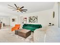 Open-concept living room with modern decor, a ceiling fan, and seamless flooring at 19724 W Palo Verde Dr, Litchfield Park, AZ 85340