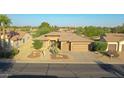 Single-story house with a two-car garage and neatly landscaped yard; view of neighborhood at 19939 N Golden Barrel Dr, Surprise, AZ 85374