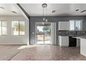 Kitchen with white cabinets, granite counters, and sliding door to backyard at 20673 N Marquez Dr, Maricopa, AZ 85138