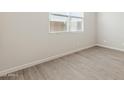 Bright bedroom with neutral walls and wood-look flooring at 21023 N 58Th Way, Phoenix, AZ 85054