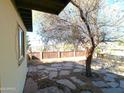 Backyard with flagstone patio and mature tree at 211 W Kiser St, Superior, AZ 85173