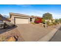 Single-story home with attached garage and landscaping at 2164 W Muirfield Dr, Anthem, AZ 85086