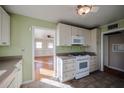 Bright kitchen with white cabinets, gas range and view to living room at 2232 N 13Th St, Phoenix, AZ 85006