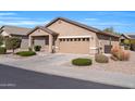 Tan one-story house with two-car garage and landscaping at 22424 W La Pasada Blvd, Buckeye, AZ 85326