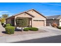 Tan one-story house with two-car garage and landscaping at 22424 W La Pasada Blvd, Buckeye, AZ 85326