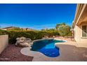 Inviting kidney-shaped pool with a rock waterfall feature at 22808 N Los Gatos Dr, Sun City West, AZ 85375