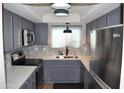 Modern kitchen with gray cabinets and quartz countertops at 2315 W Union Hills Dr # 112, Phoenix, AZ 85027