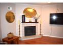 Cozy living room with a decorated fireplace and a mounted television at 2315 W Union Hills Dr # 112, Phoenix, AZ 85027