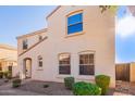 Tan two-story house with a walkway and shrubs at 2613 E Bart St, Gilbert, AZ 85295