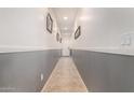 Bright hallway with gray and white walls and tile flooring at 26538 N 132Nd Ln, Peoria, AZ 85383