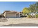 Single-story home with a two-car garage and landscaped front yard at 30034 N 128Th Ave, Peoria, AZ 85383